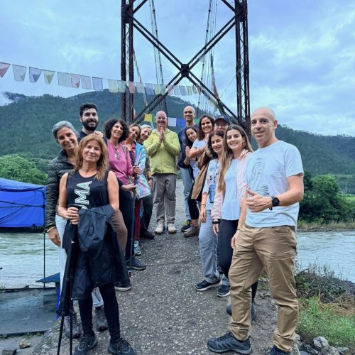 Grupo de portugueses posa à frente de uma ponte suspensa no Butão.